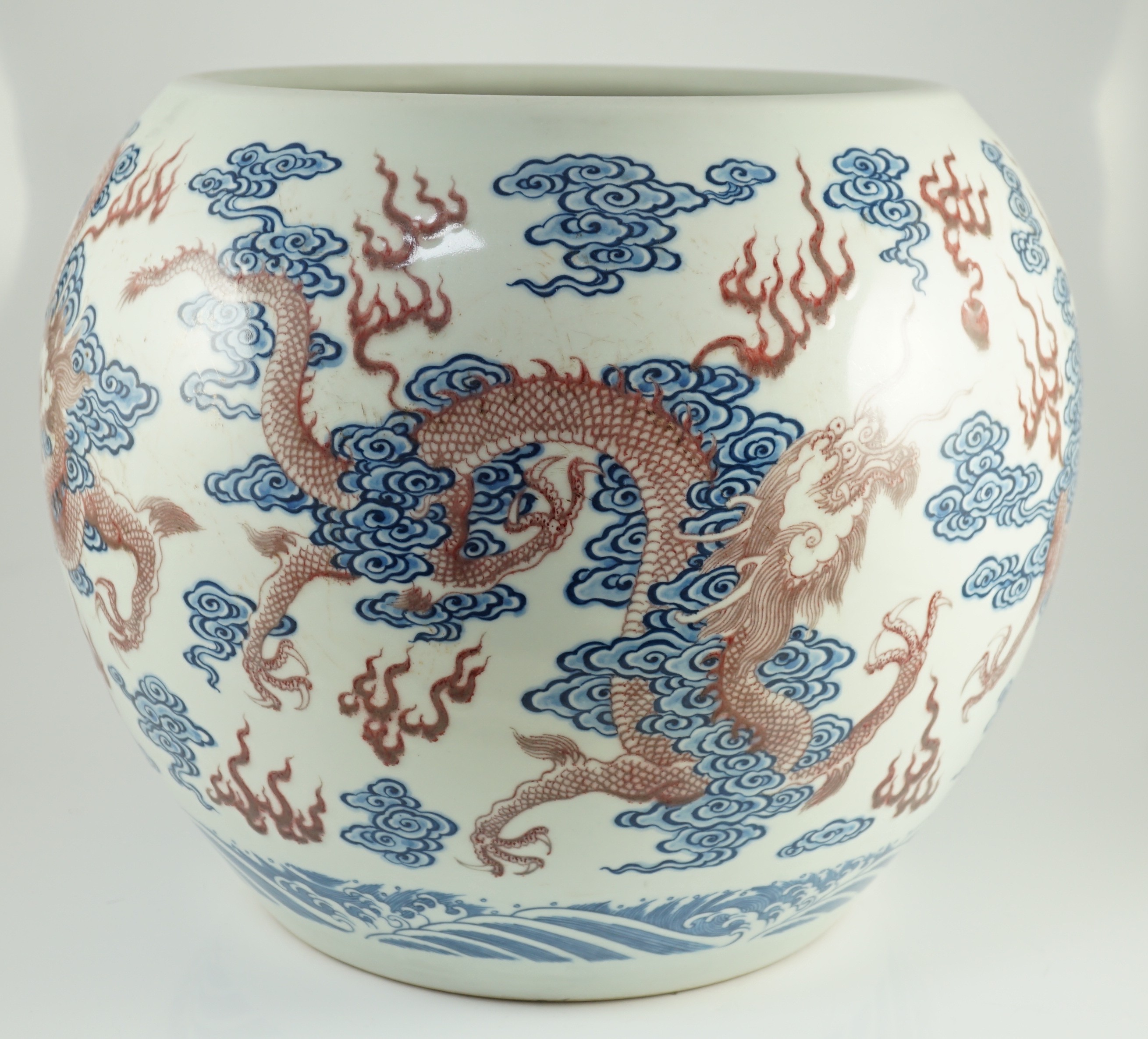 A large Chinese underglaze blue and copper red 'dragon' scroll vessel, 42.5cm diameter, 34.5cm high